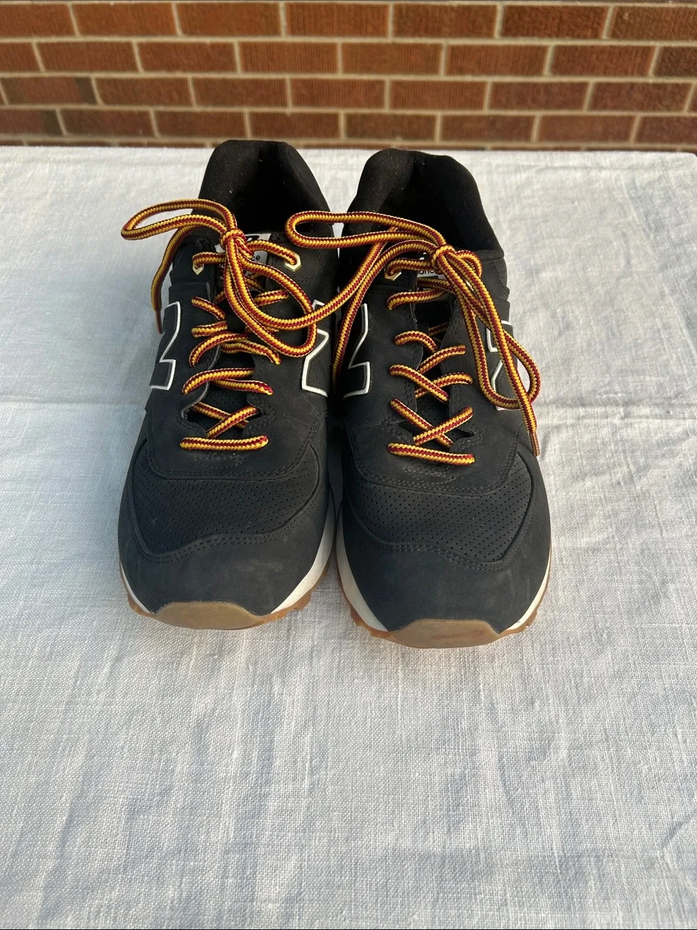 New Balance Men’s Black Sneakers with Tan Sole and Yellow-Orange Laces